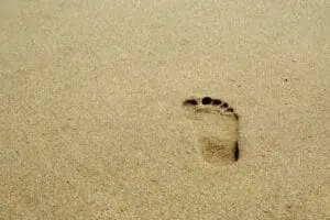 Single human footprint in smooth sand.