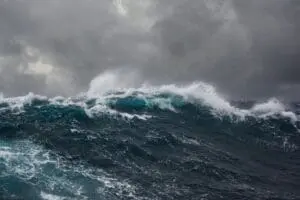 Powerful ocean waves under a stormy sky.