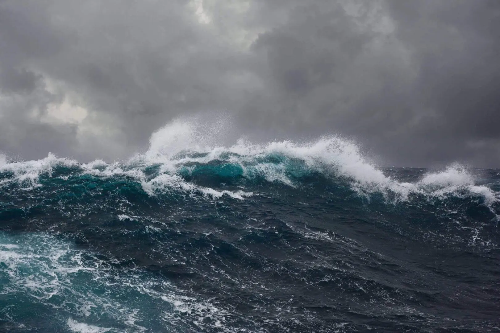 Powerful ocean waves under a stormy sky.