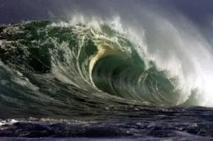 A powerful ocean wave curling with white foam.