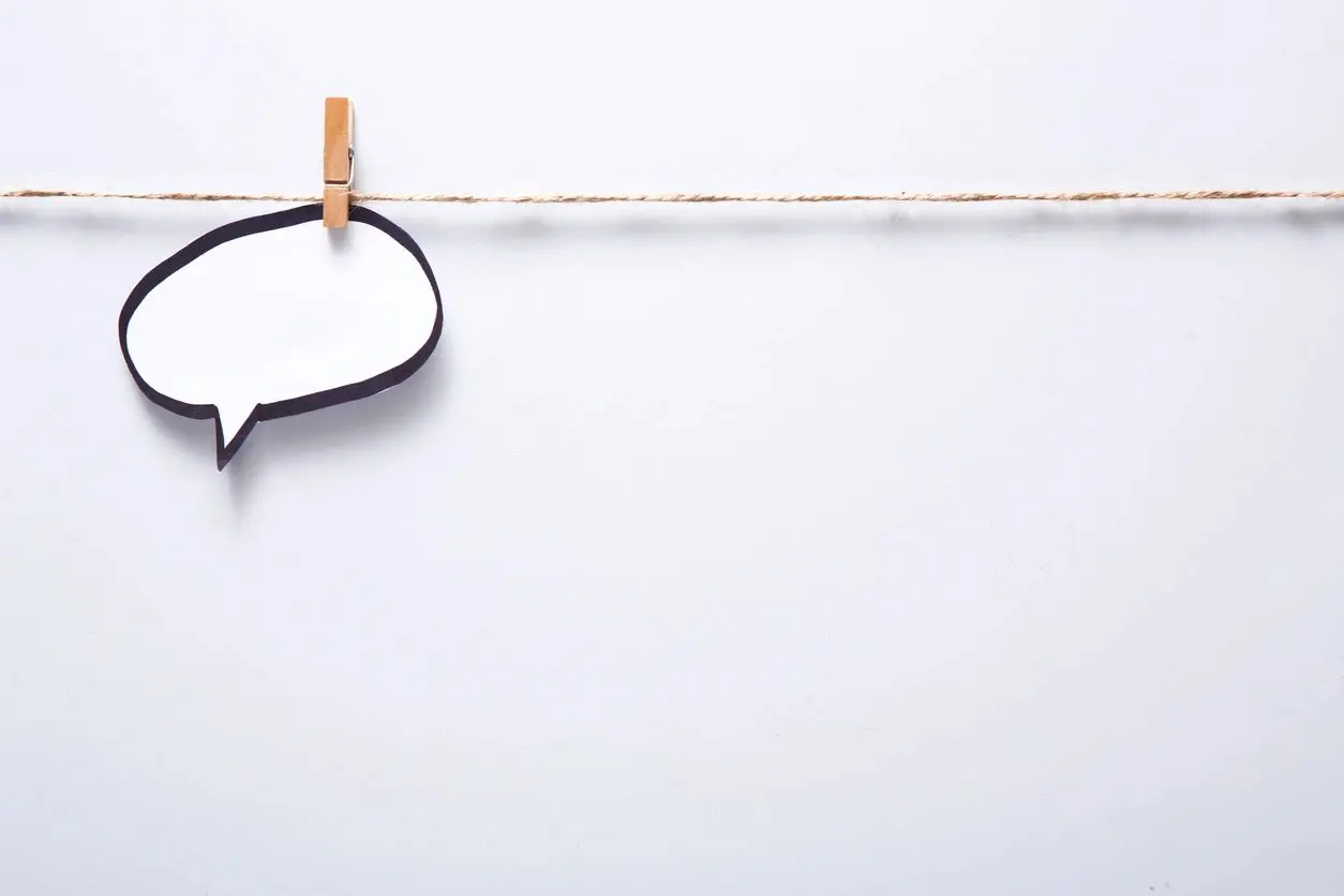 A blank speech bubble pinned with a clothespin on a line.