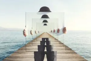 Surreal image of a man with a hat on a pier, repeated in transparent frames.