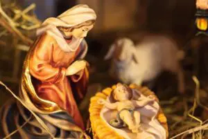 Nativity scene with Mary, baby Jesus, and a lamb.