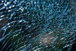 Close-up of shattered glass with intricate cracks.