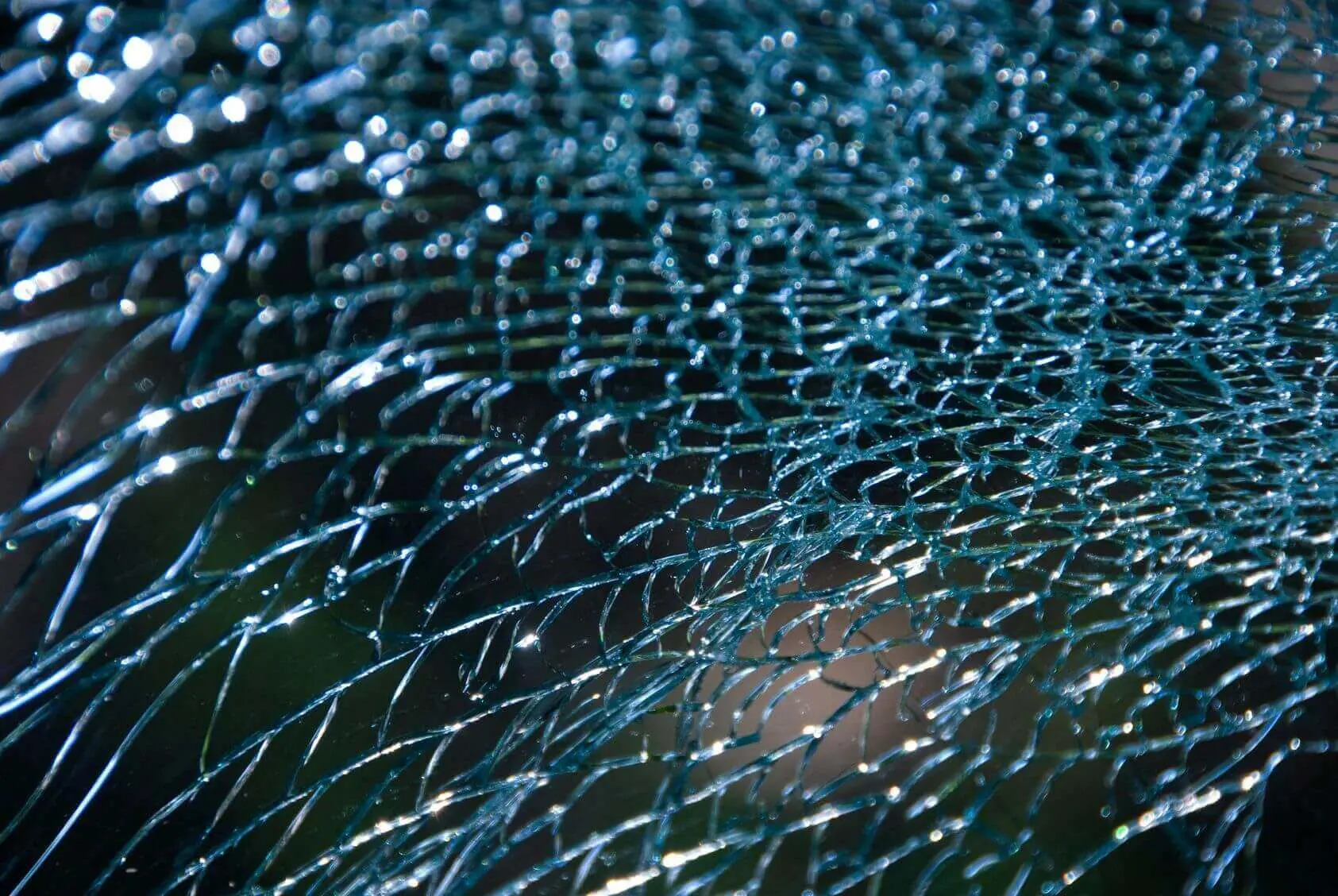 Close-up of shattered glass with intricate cracks.