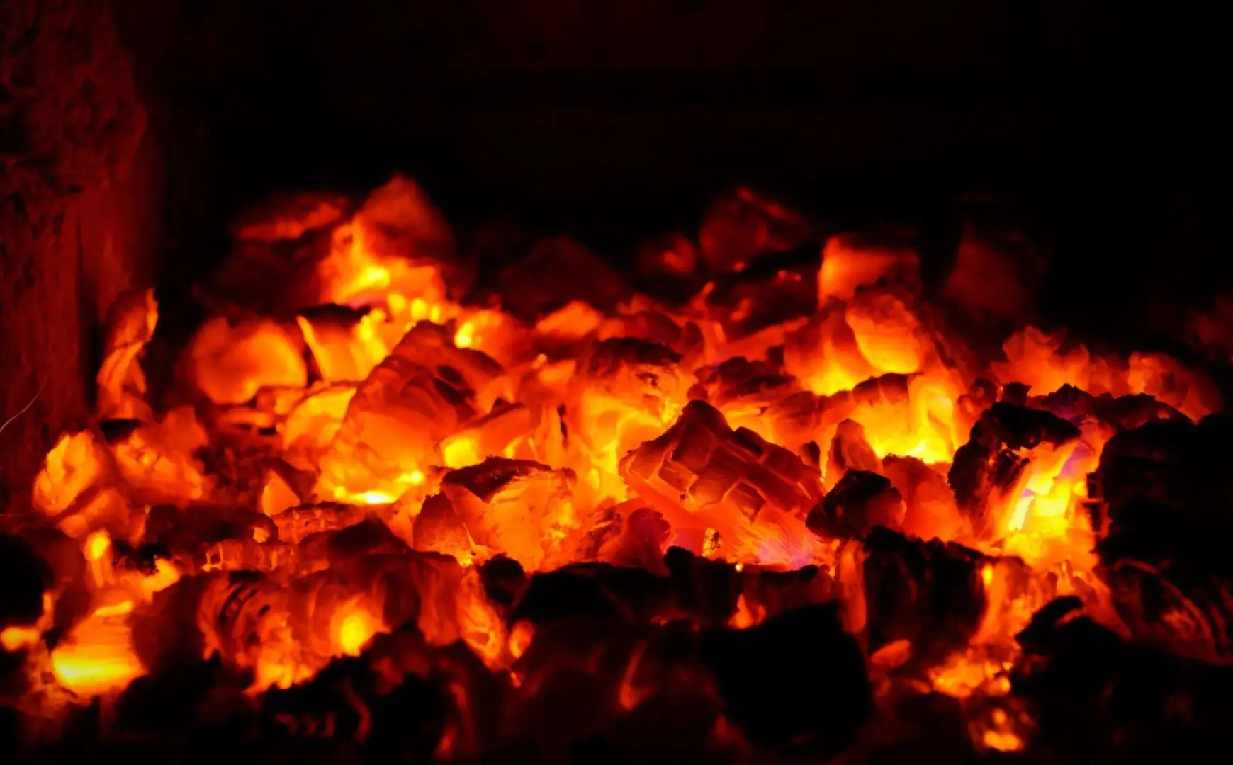 Glowing red-hot embers emitting intense heat.