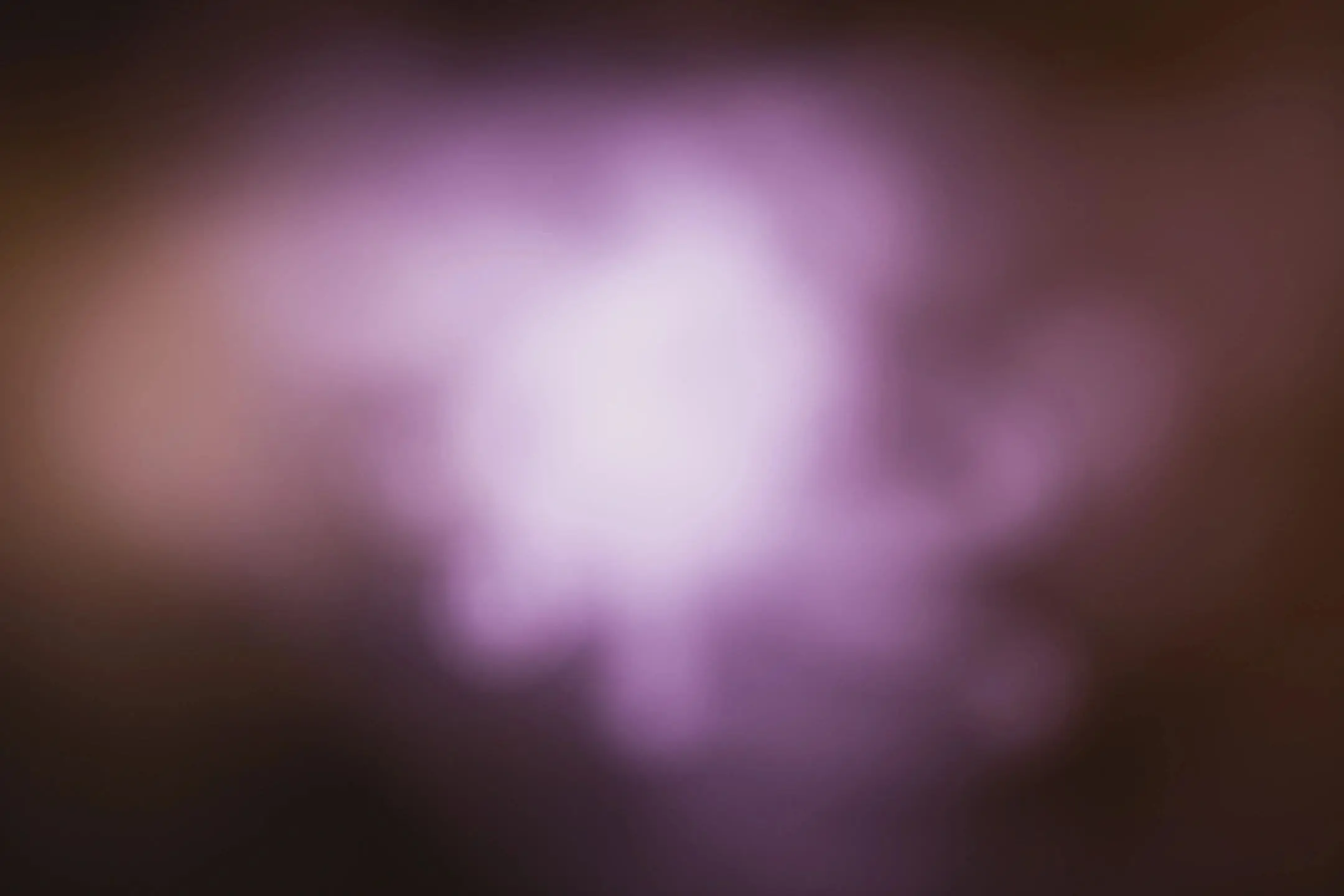 Blurred purple and white light creating a soft, dreamy effect.