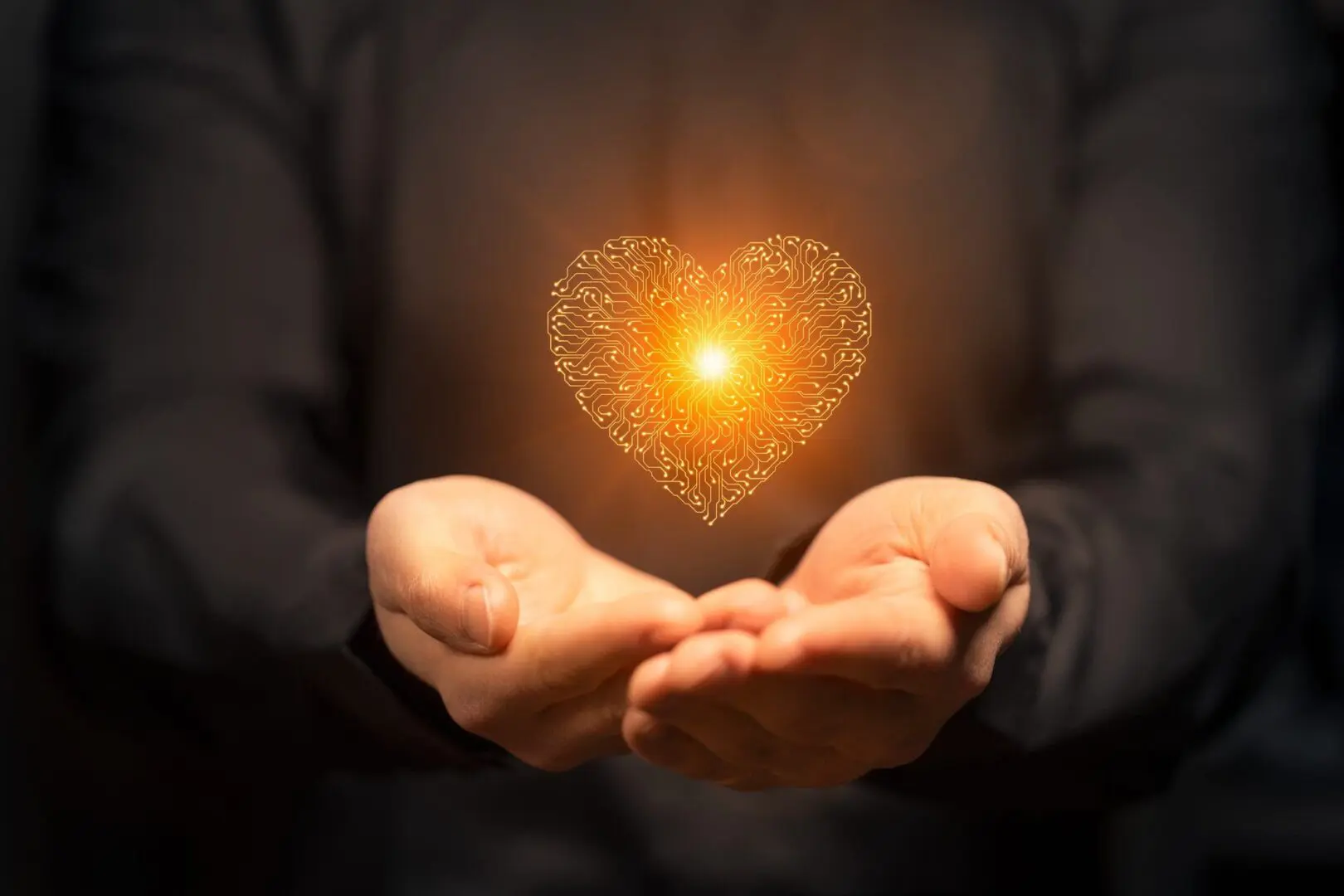 Hands holding a glowing heart made of light particles.