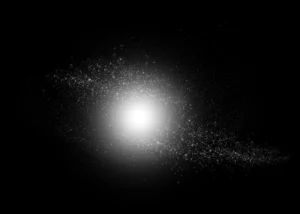 Bright central glow with surrounding specks on a black background.