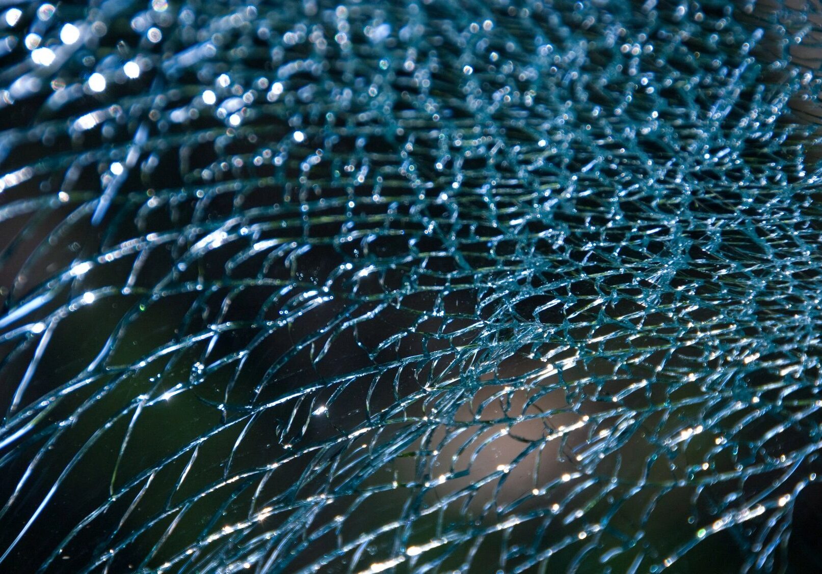 Close-up of shattered glass with intricate cracks.