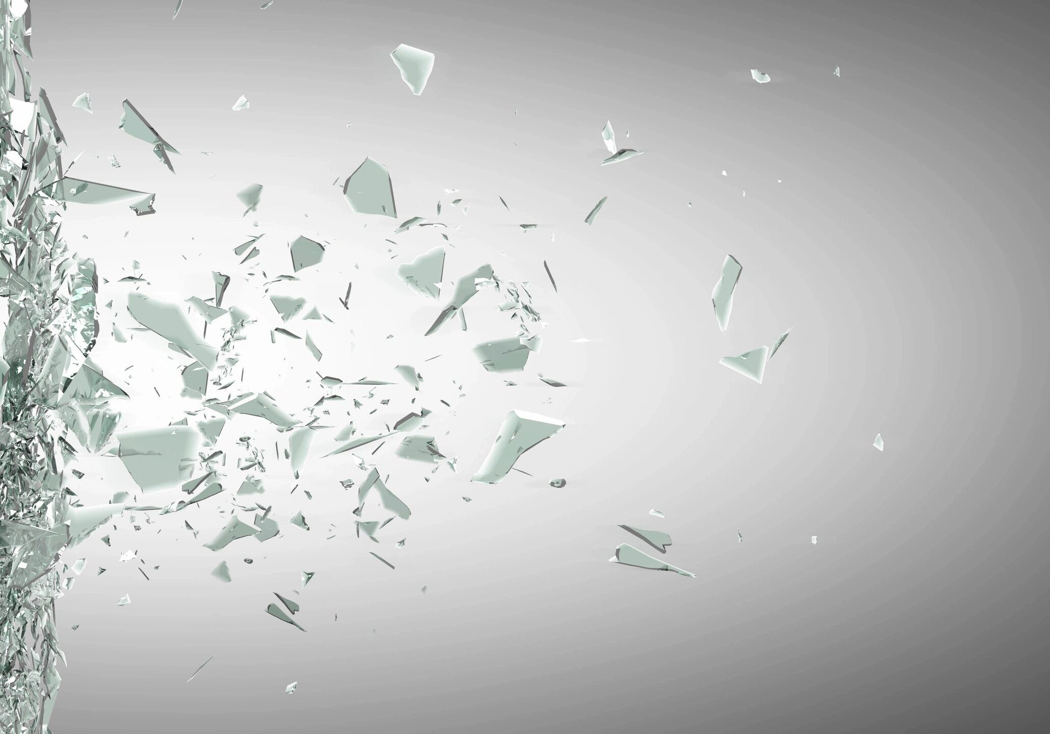 Glass shards shattering mid-air against a gray background.