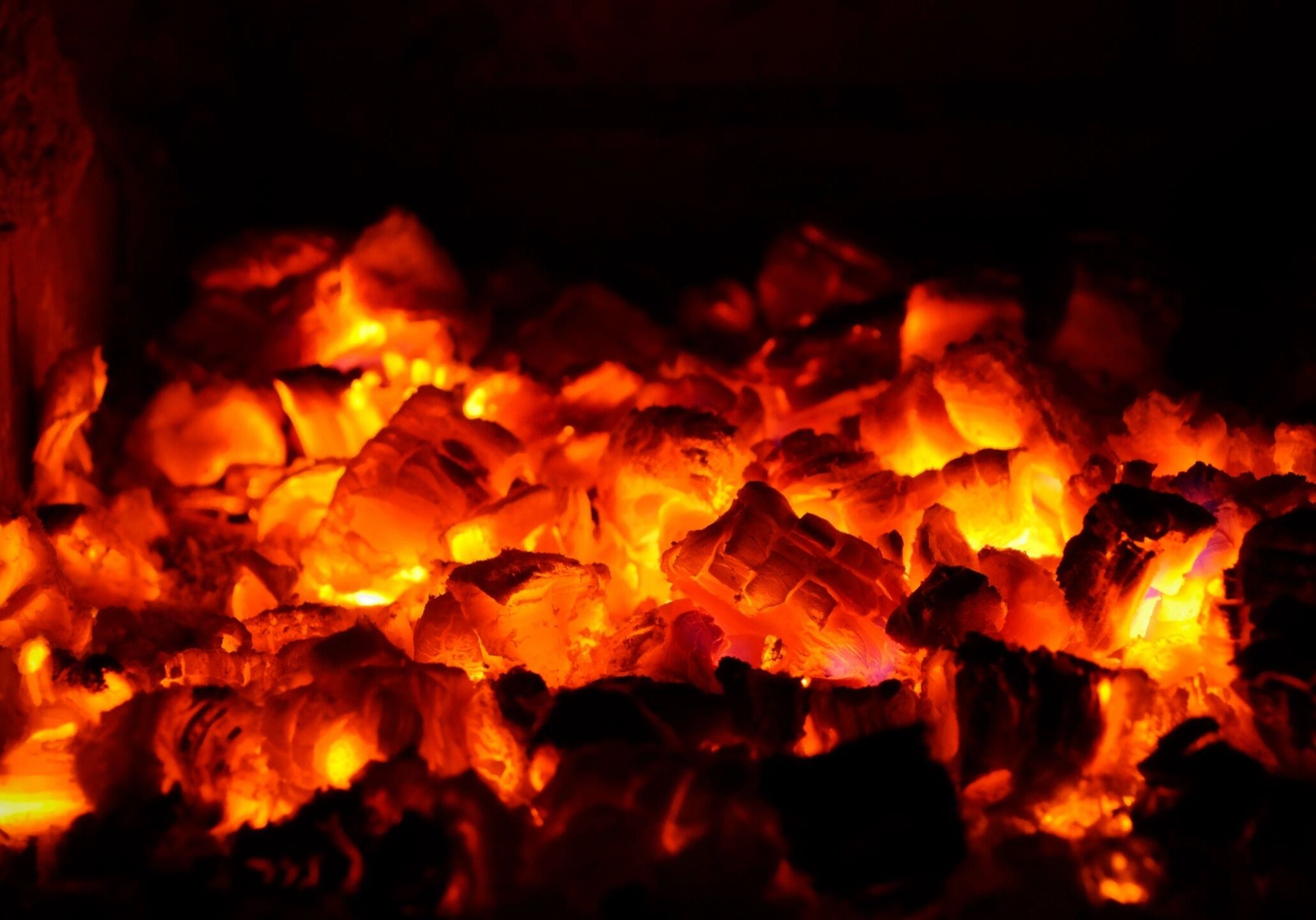 Glowing red-hot embers emitting intense heat.