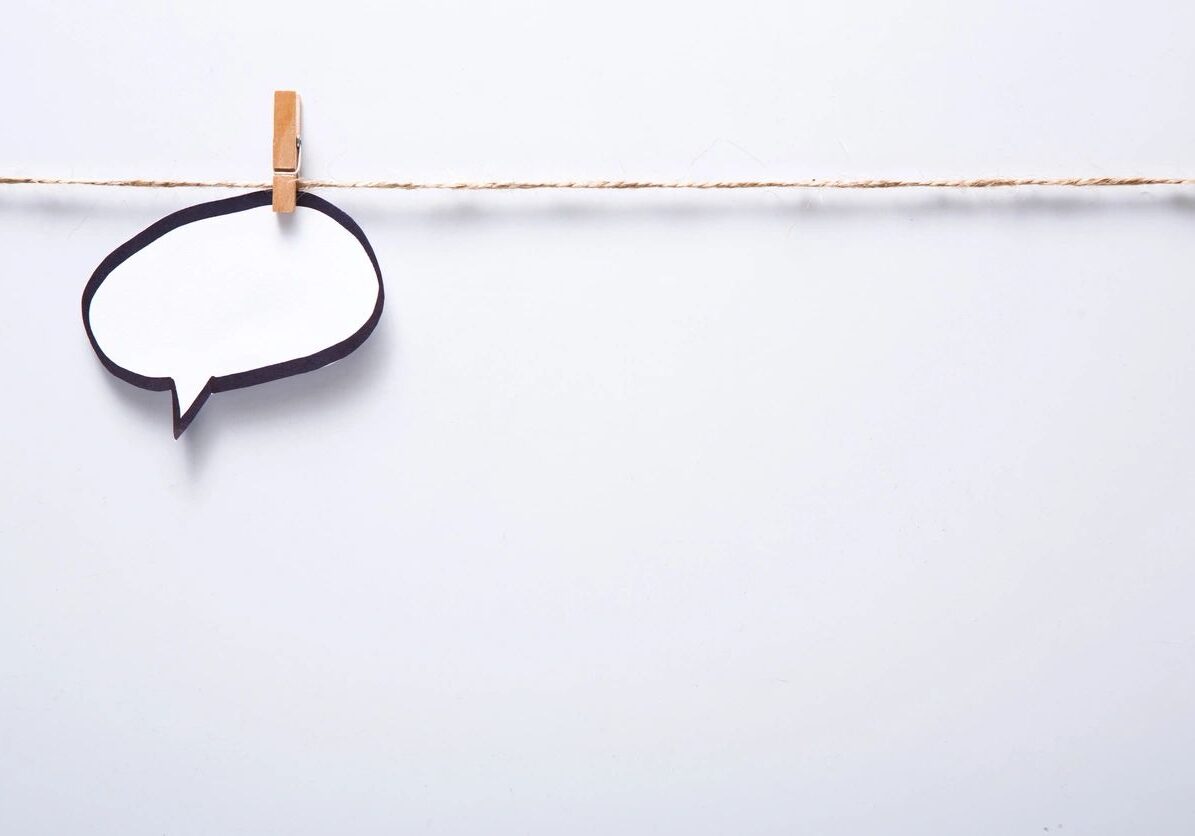 A blank speech bubble pinned with a clothespin on a line.