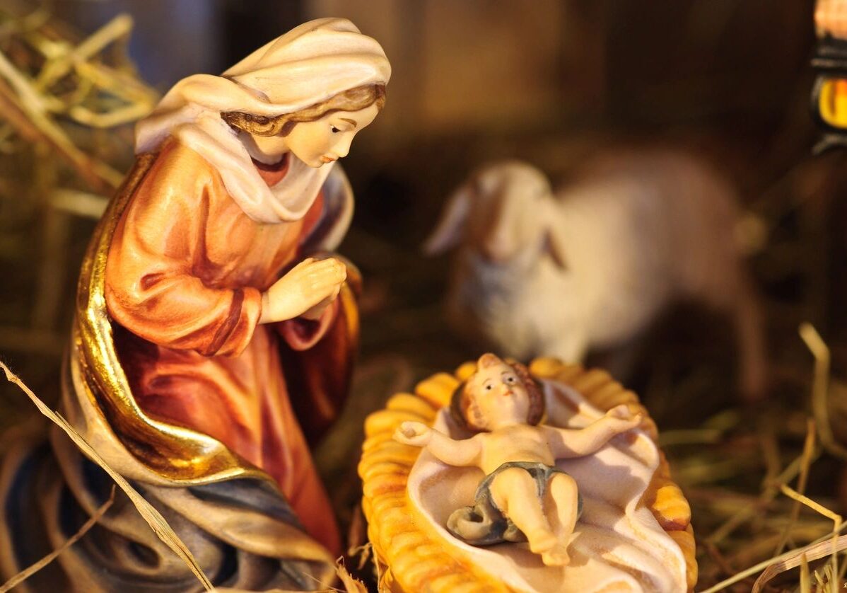 Nativity scene with Mary, baby Jesus, and a lamb.