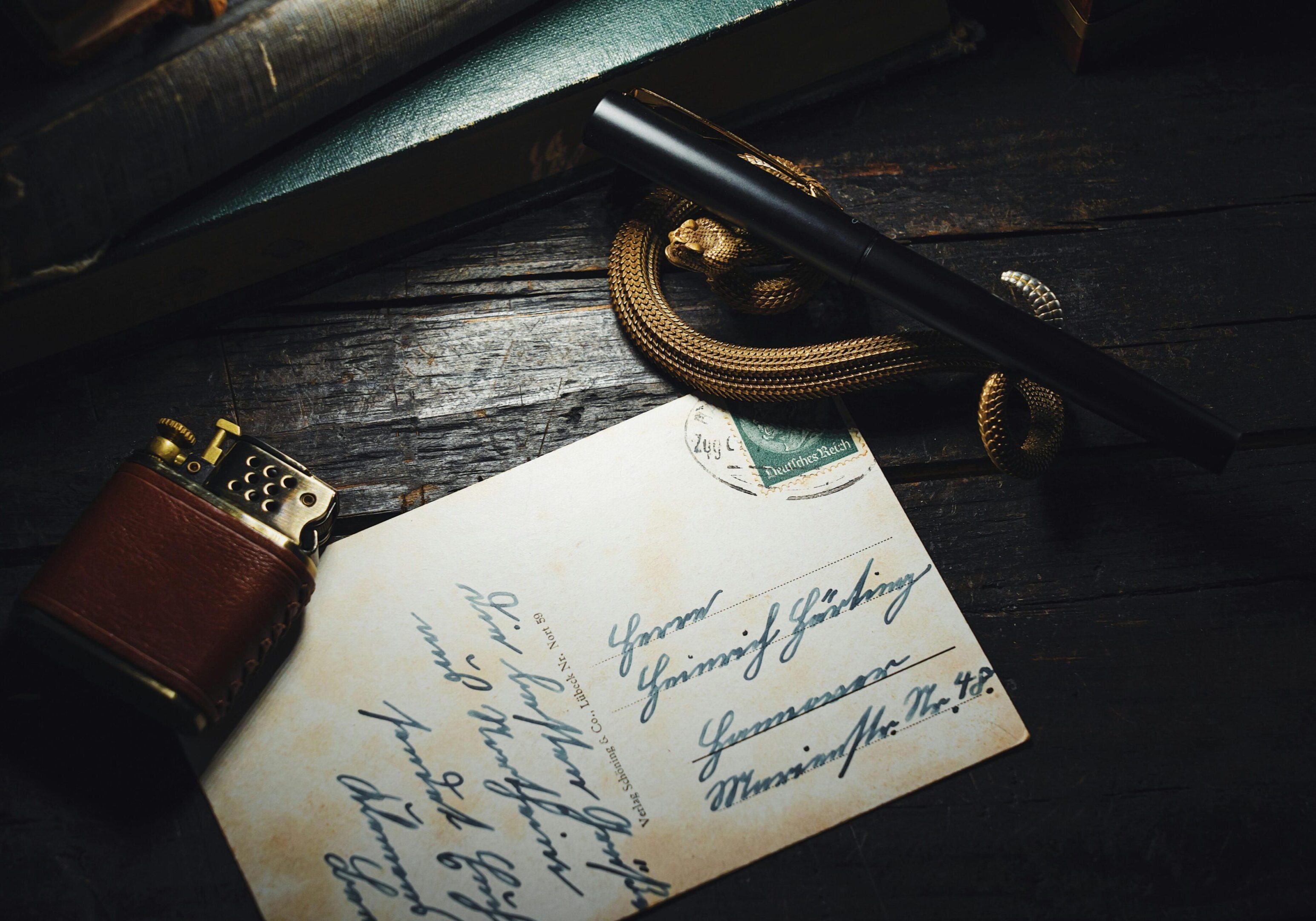 Vintage handwritten letter with a fountain pen and pocket watch.